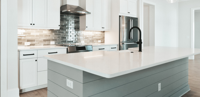 luxury kitchen with white countertops and gray and white cabinetry