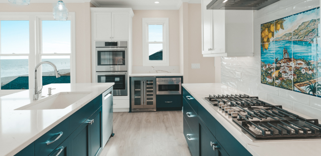 luxury coastal kitchen with blue cabinetry and white countertops